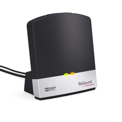 A ReSound Unite TV Streamer 2 in black and silver with Dolby Digital branding, green and yellow front indicator lights, and a rear cable, shown against a white background.