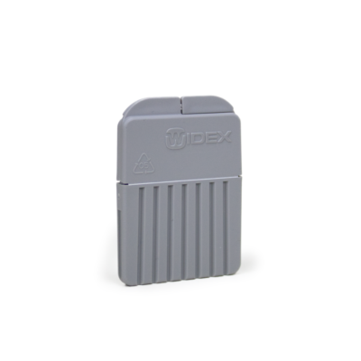 A gray plastic Widex battery holder with a ridged base stands upright beside a Widex CeruStop XL, both displayed against a white background for hearing aid maintenance.